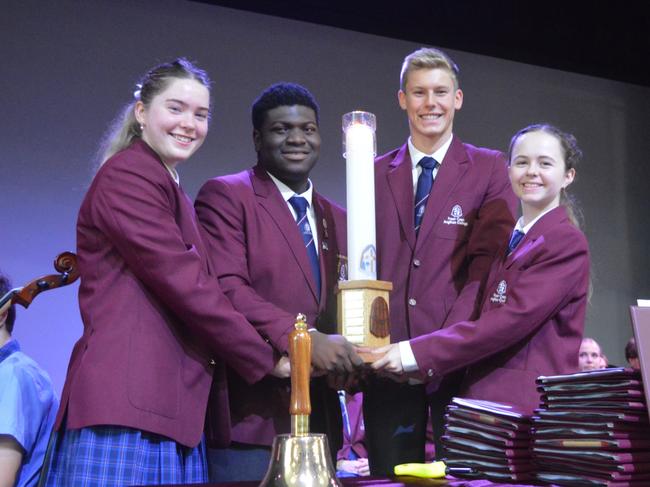 Fraser Coast Anglican College 2023 school captains Madison Zanella and Bolu Sonubi hand over the baton to the new school captains Xavier Metcalfe and Maya Mikkelsen.