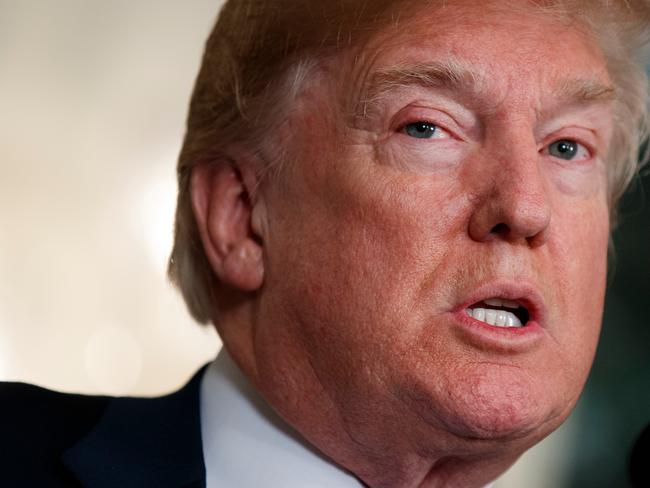 FILE - In this March 22, 2018, photo, President Donald Trump speaks before he signs a presidential memorandum imposing tariffs and investment restrictions on China in the Diplomatic Reception Room of the White House, in Washington. South Korea says it is trying to find out what President Donald Trump meant when he made remarks linking the recently renegotiated South Korea-U.S. free trade agreement with talks on denuclearizing North Korea. South Korean President Moon Jae-in's office said Friday, March 30, 2018, that it is working through various channels to find out the President Trump's intentions following his speech in Ohio.(AP Photo/Evan Vucci, File)