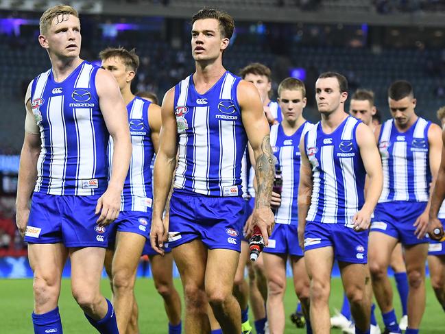 MELBOURNE, AUSTRALIA - APRIL 02: Jack Ziebell and his Kangaroos team mates look dejected after losing the round 3 AFL match between the North Melbourne Kangaroos and the Western Bulldogs at Marvel Stadium on April 02, 2021 in Melbourne, Australia. (Photo by Quinn Rooney/Getty Images)