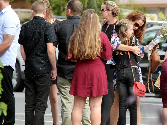 Sole-survivor Chloe-May is comforted at the funeral of her mum and siblings. Picture: Nathan Edwards