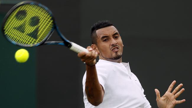 Australia’s Nick Kyrgios returns to Pierre-Hugues Herbert of France.