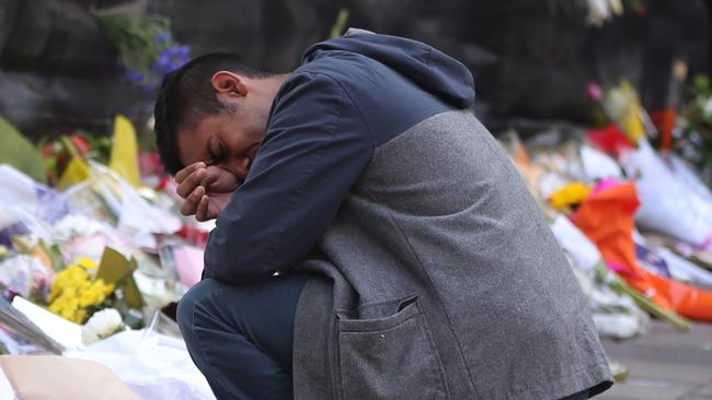 An emotional Joel Herat at the memorial site in Martin Place after the siege. Picture: John Grainger