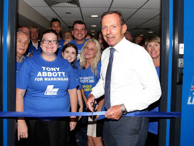 Tony Abbott cuts the ribbon on Monday night to launch his federal election campaign office in the fight to retain the seat of Warringah. Picture: Jonathan Ng