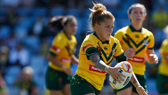 Caitlin Moran runs the ball for Australia against England at Southern Cross Group Stadium.