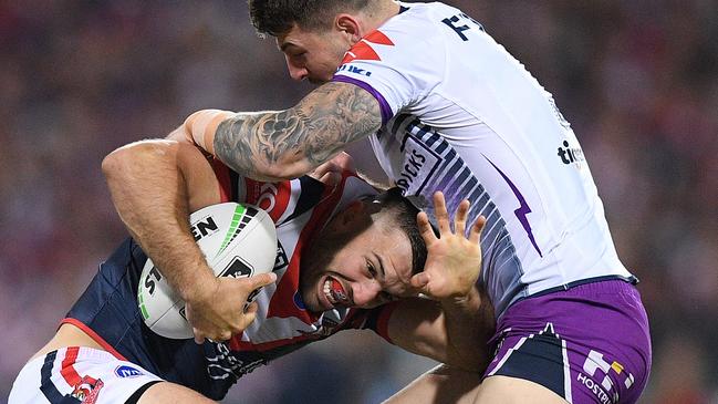 James Tedesco runs into Storm star Curtis Scott on Saturday night.