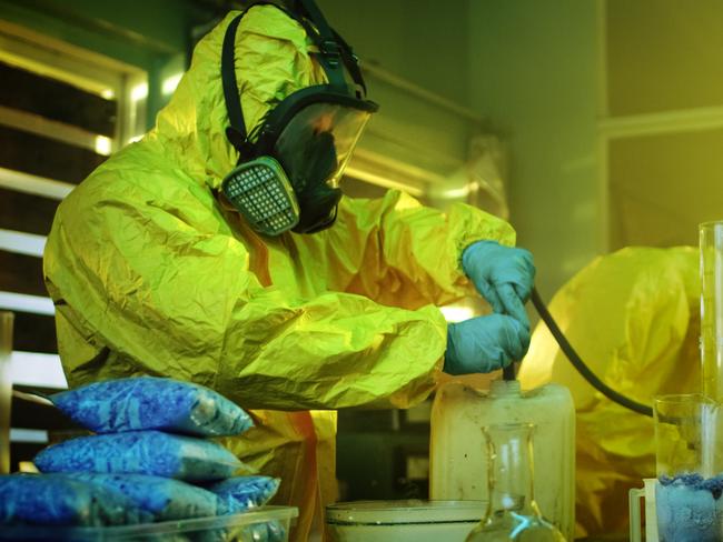 Meth lab generic 2020: In the Underground Drug Laboratory Two Clandestine Chemists Wearing Protective Masks and Coveralls Use Hosepipe For Drug Distillation. They Cook Synthesised Drugs in the Abandoned Building. iStock.