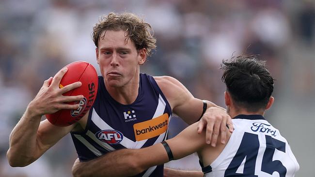 GEELONG, AUSTRALIA - MARCH 15: Matthew Johnson of the Dockers is tackled by Brad Close of the Cats during the round one AFL match between Geelong Cats and Fremantle Dockers at GMHBA Stadium, on March 15, 2025, in Geelong, Australia. (Photo by Daniel Pockett/Getty Images)