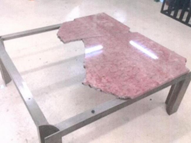 Damaged ... a picture of the broken marble table that was provided to the Committee. Picture: Supplied.