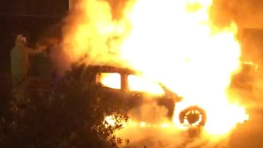 Emergency services worked to put out the torched car at Biggera Waters overnight. 