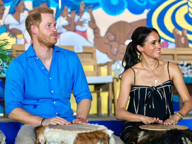 Prince Harry and Meghan Markle play drums at La Boquilla drum school in Cartagena, Bolivar department, Colombia. Picture: AFP