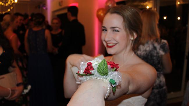 Holly Weyman-Jones shows off her corsage at the St John's Formal in Roma on Friday night.