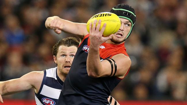 Angus Brayshaw gets a handball away from Patrick Dangerfield. Picture: Michael Klein