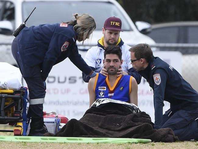 Tyab captain Ethan Rahilly is taken off the field by paramedics during the MPNFL Div 2: Tyabb v Devon Meadows match in Tyabb, Saturday, July 27, 2019. Picture: Andy Brownbill