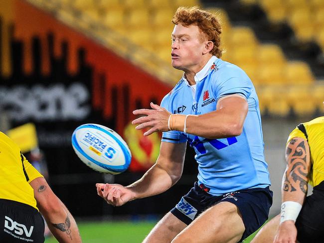 Waratahs' Tane Edmed passes the ball during the Super Rugby match between the Wellington Hurricanes and NSW Waratahs at the Sky Stadium in Wellington on May 3, 2024. (Photo by Grant Down / AFP)