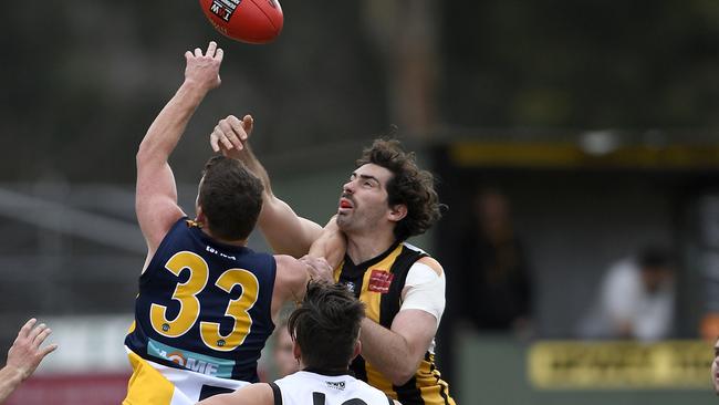 Beaconsfield’s Jacob Patullo does battle with Upwey Tecoma’s Liam O’Brien. Picture: Andy Brownbill