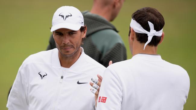 LONDON, ENGLAND - JULY 07: Rafael Nadal of Spain greets Roger Federer of Switzerland during a practice session during Middle Sunday of The Championships - Wimbledon 2019 at All England Lawn Tennis and Croquet Club on July 07, 2019 in London, England. (Photo by Matthias Hangst/Getty Images)