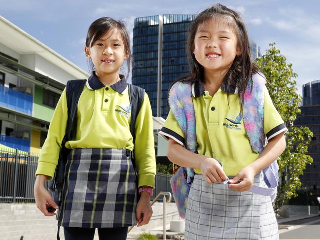 Infrastructure like schools cannot keep up with demand for new developments in Sydney. Wentworth Point Public School was built a couple of years ago but is already at capacity and the playground has started to be taken over by demountables. Students Madison Miranda, 8, (L) and her friend Jacqueline Tjie, 7 (R) outside the school. Picture: Jonathan Ng