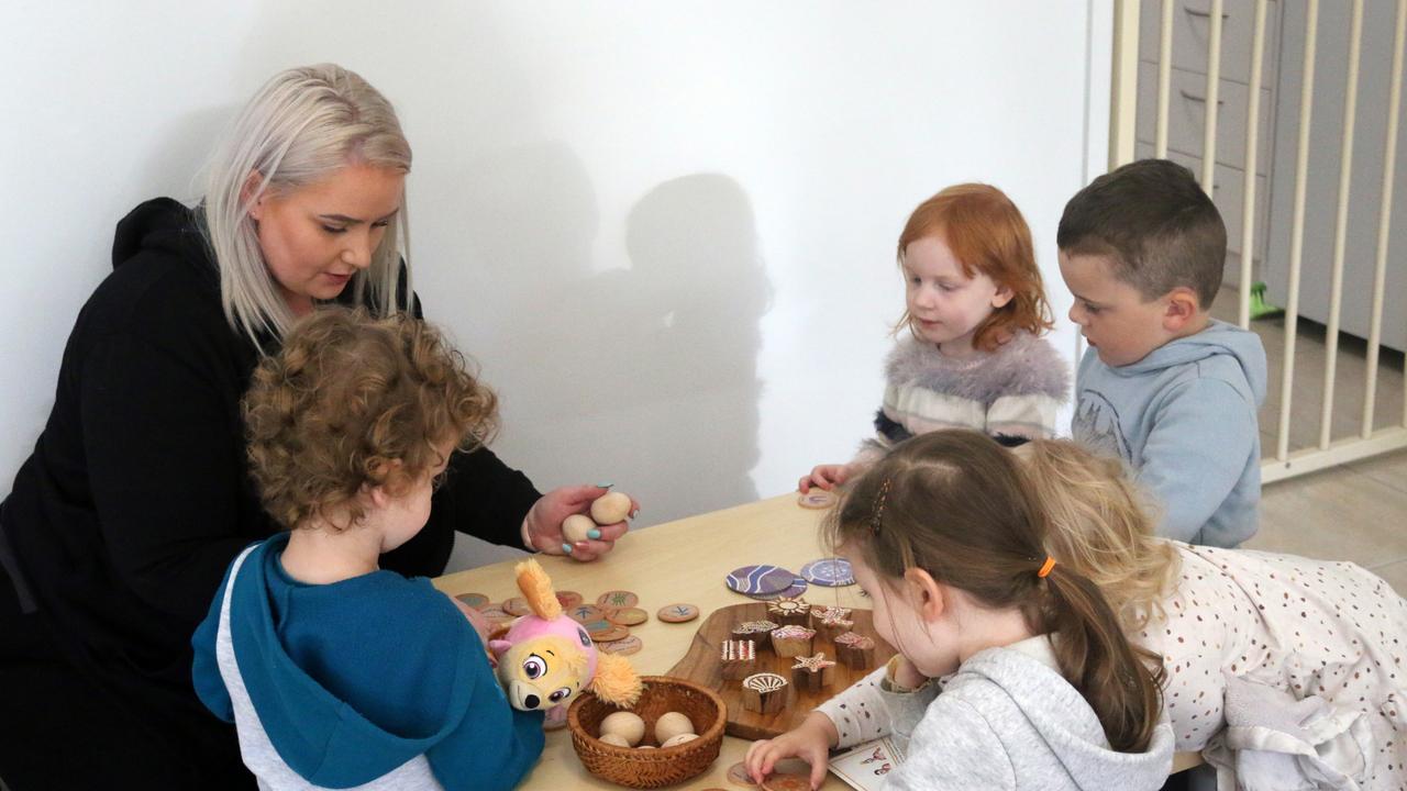 Harlin, Imogen, Violette, Cooper, and Rosalie doing an activity with Jacinta.