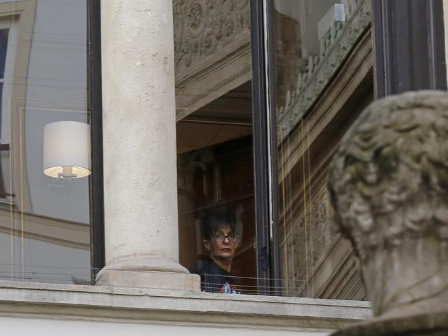 A woman looks out of a window of the residence in which Kim Kardashian was robbed in Paris. Picture: AP Photo/Michel Euler