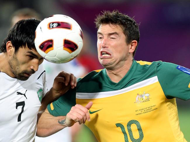 Australia's midfielder Harry Kewell (R) vies for the ball with Uzbekistan's midfielder Azizbek Haydarov during their 2011 Asian Cup semi-final football match in the Qatari capital Doha on January 25, 2011. AFP PHOTO/YASSER AL-ZAYYAT