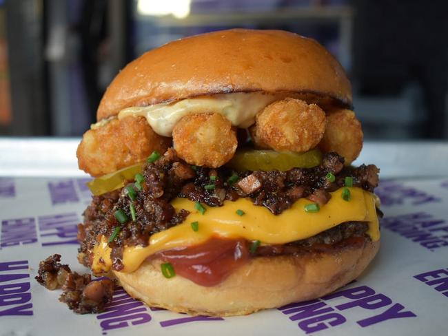 Happy Ending Burgers’ Napoleon Dynamite includes a dry aged beef patty, double American cheese, bacon jam, grilled shallots, caper mayo, tater tots and balsamic ketchup. Picture: Facebook