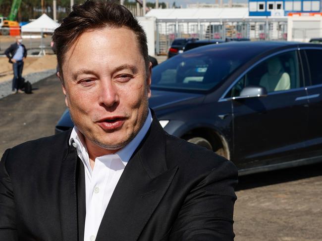 FILES) In this file photo Tesla CEO Elon Musk talks to media as he arrives to visit the construction site of the future US electric car giant Tesla in Gruenheide near Berlin on September 3, 2020. - Tesla delivered a record number of cars in 2020, the company said, just narrowly missing its half a million target for the year. The pioneering high-end electric vehicle maker delivered 180,570 cars to customers and produced 179,757 in the fourth quarter of the year, it said in a statement on January 2, 2021. (Photo by Odd ANDERSEN / AFP)