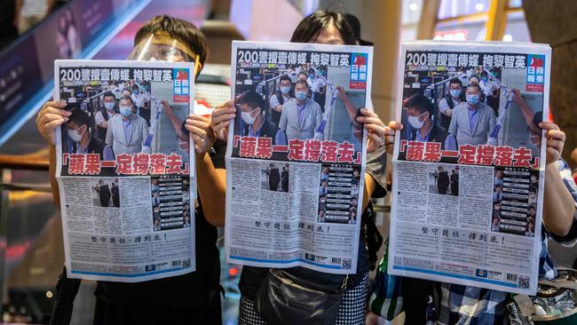 Protesters hold copies of the Apple Daily as they rally for press freedom in Hong Kong. Picture: AFP.