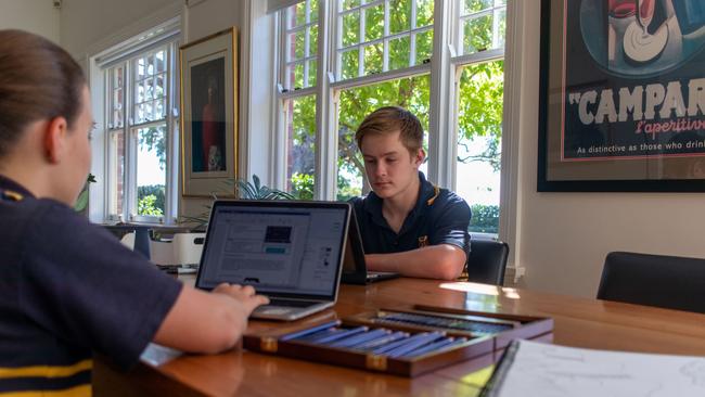 Scotch College students Holly, 12, year 7, and Noah, 14, year 9, working at home using online remote learning in March, 2020.