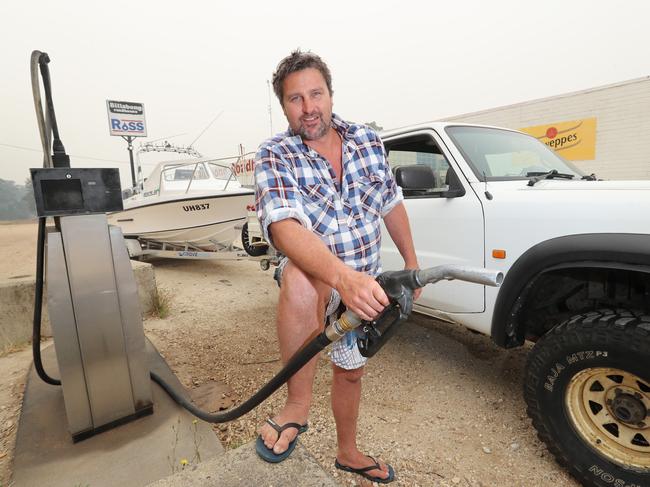 City motorists are getting slugged more than 40 cents a litre for petrol than their country counterparts. Ben Toseland fills up at the Billabong Roadhouse in Fernbank. Picture: Alex Coppel