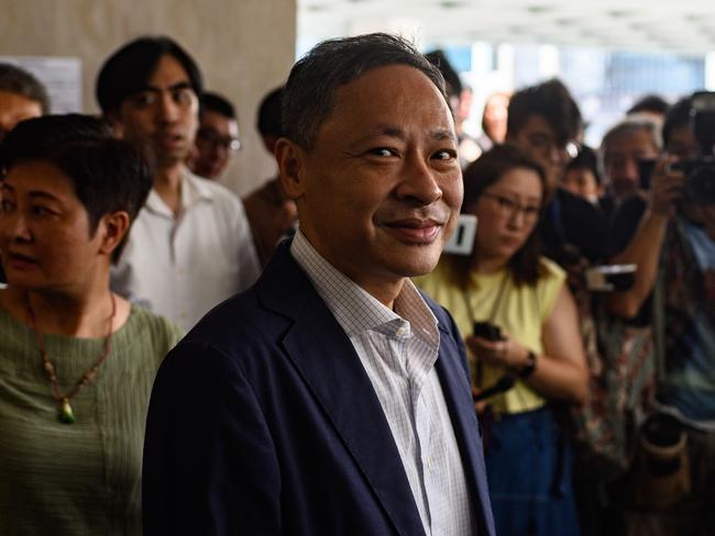 Hong Kong law professor and pro-democracy activist Benny Tai (C) stands in front of the media outside the High Court following his release on bail. Picture: AFP