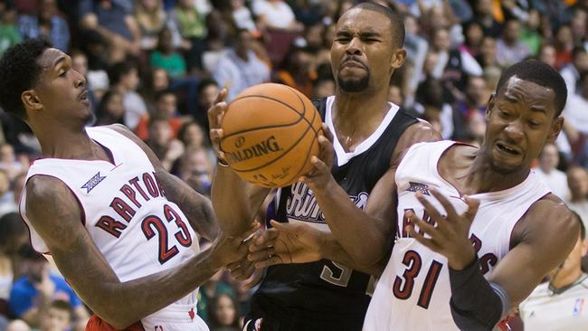 Sacramento Kings' Ramon Sessions is fouled by Toronto Raptors' Terrence Ross.