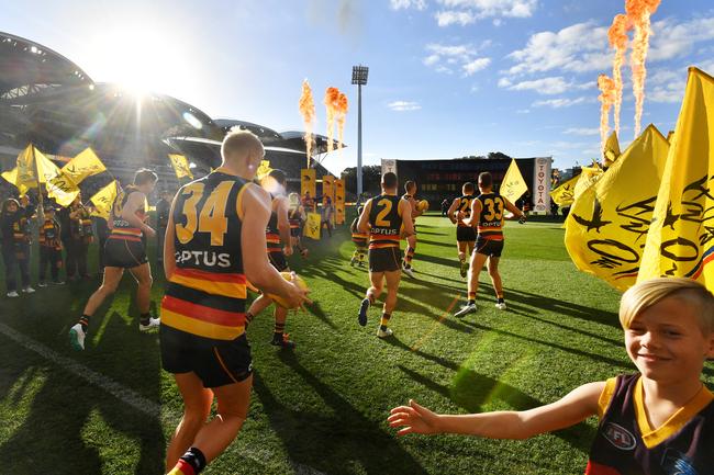 Crows players run onto the field during the Round 7 AFL match between the Adelaide Crows and the Fremantle Dockers at the Adelaide Oval in Adelaide, Sunday, May 5, 2019. (AAP Image/David Mariuz) NO ARCHIVING, EDITORIAL USE ONLY