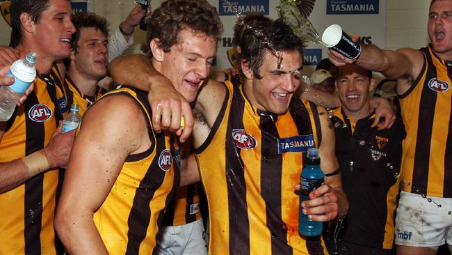 Josh Kennedy (right) is covered in Gatorade after playing in his first win for Hawthorn.