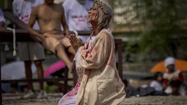 Penitent Wilfredo Salvador kneels in prayer before he is nailed to a cross during Good Friday crucifixions on April 7, 2023 in San Fernando, Pampanga, Philippines.