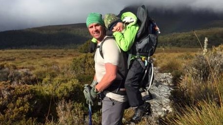 In 2015, Chris carried then 10-year-old son Jack on his back while walking the 65km Overland Track. Picture: Supplied