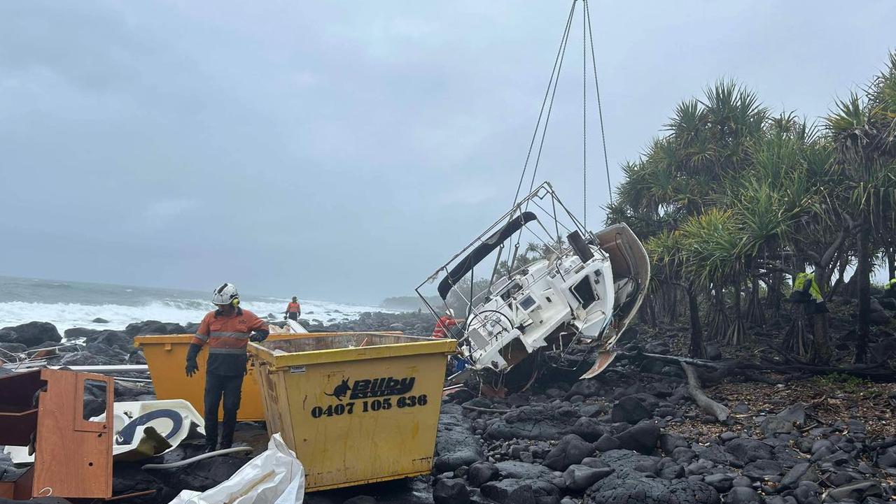 Wide Bay Cranes lift sections of the wrecked yacht over the trees, aiding in the complex recovery. Picture: Facebook