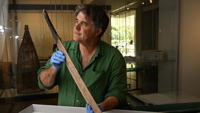 Archaeologist Michael Westaway with an Indigenous rainforest sword recovered from an archaeological dig in far western Queensland. Picture: Lyndon Mechielsen