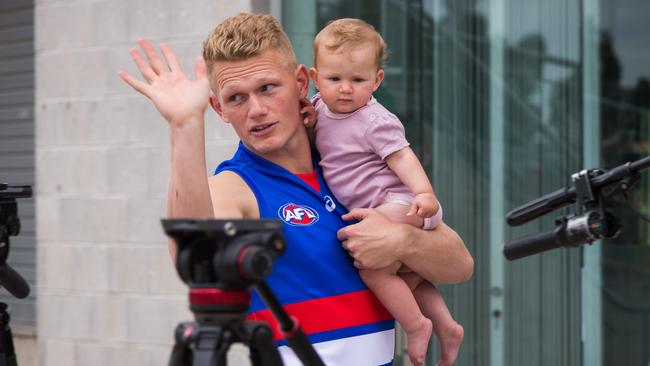 New Western Bulldogs recruit Adam Treloar with his baby girl Georgie at Whitten Oval in Footscray. The star midfielder was traded to the Bulldogs in a last-minute deal with Collingwood. Picture: NCA NewsWire/Paul Jeffers