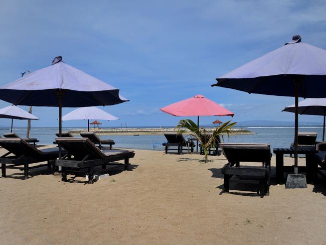 Empty deck chairs as seen by the beach in Sanur, near Denpasar on Indonesia's resort island of Bali. Picture: AFP