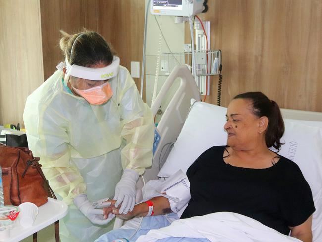 Registered nurse Dawn Medan tends to Covid-positive patient Charmaine Pangi at Mackay Base Hospital. Picture: Contributed