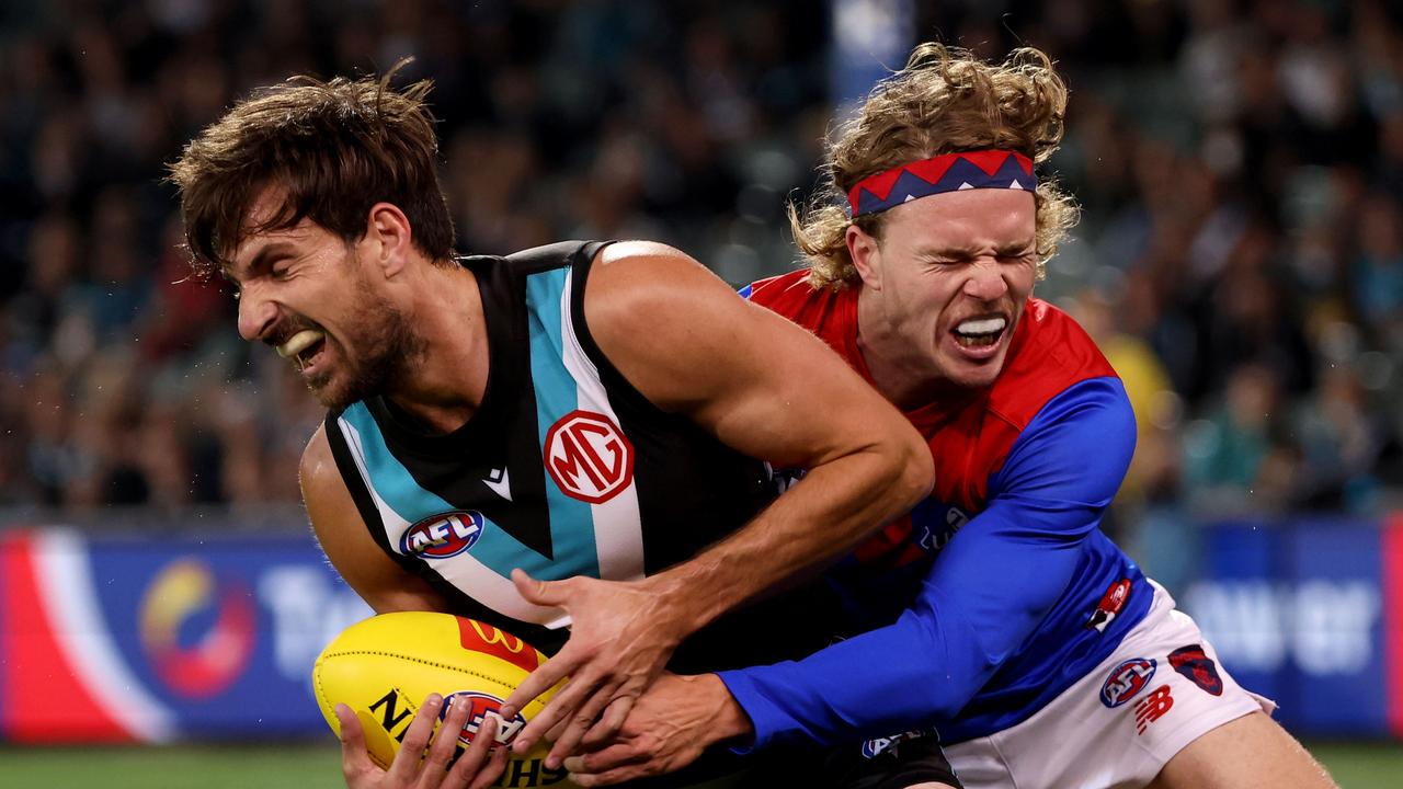 Sam Mayes is tackled by Jayden Hunt as Port failed to kick a goal before halftime for the first time in its history. Picture: AFL Photos via Getty Images