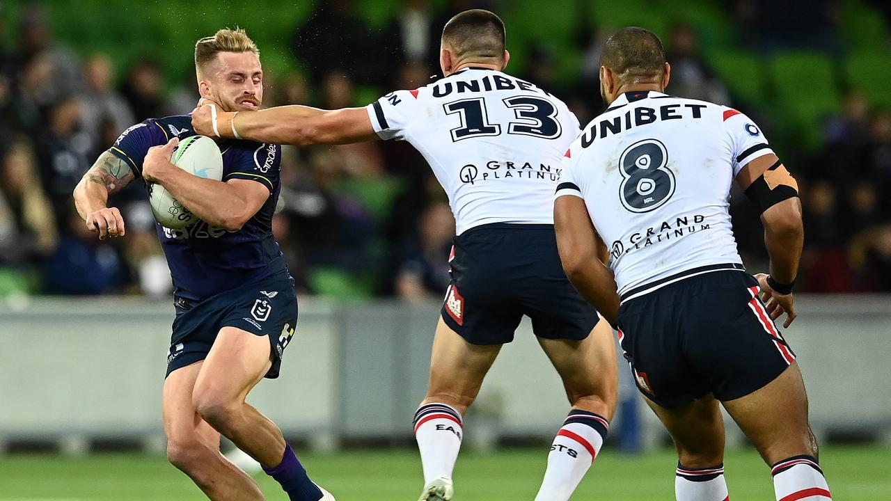 Cameron Munster of the Storm is tackled high by Victor Radley of the Roosters (Photo by Quinn Rooney/Getty Images)