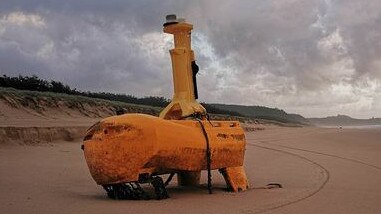 A mystery yellow object has washed up on Teewah Beach with speculation rife online as to its use. Picture: Geoff Feeley