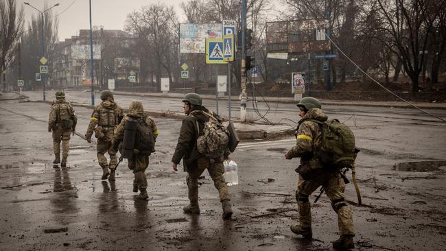 Members of the Ukrainian military move through the streets of Bakhmut. Picture: Getty