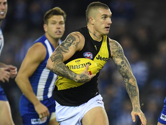 Dustin Martin of the Tigers (centre) is seen in action during the Round 11 AFL match between the North Melbourne Kangaroos and the Richmond Tigers at Etihad Stadium in Melbourne, Saturday, June 3, 2017. (AAP Image/Julian Smith) NO ARCHIVING, EDITORIAL USE ONLY