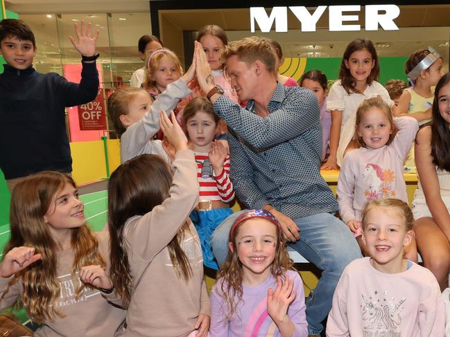 Kids pose for a photo with Cody Simpson at a meet-and-greet at Robina Town Centre outside Myer . Picture Glenn Hampson