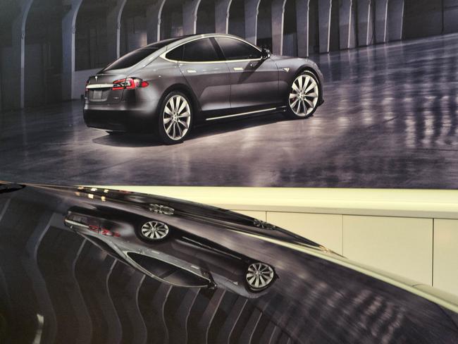 An image of a Tesla model X is seen reflected on the bonnet of a new model 3 in the Tesla showroom in Santa Monica, California. Picture: Richard Vogel
