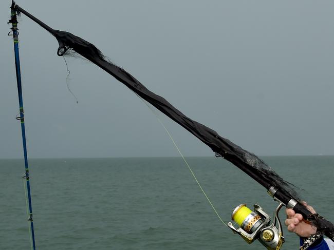 Thunder storm dumps rain and lightning on Townsville. Eugene Dryden had a lucky escape when lightning struck his fishing rod at the rock pool. Picture: Evan Morgan