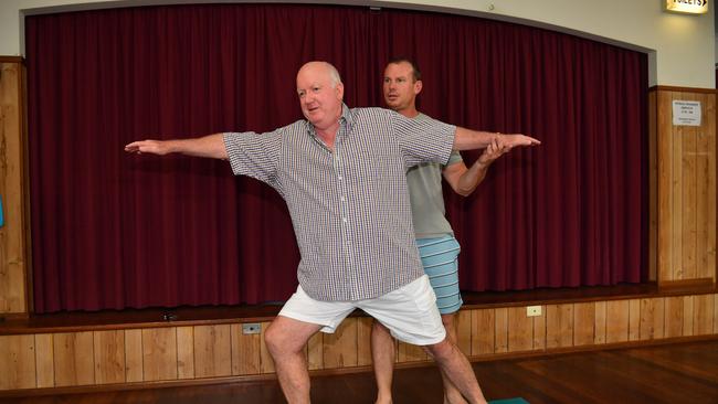 Yoga instructor David Kinnane does some yoga with Roy Nielsen.  Photo: John McCutcheon / Sunshine Coast Daily