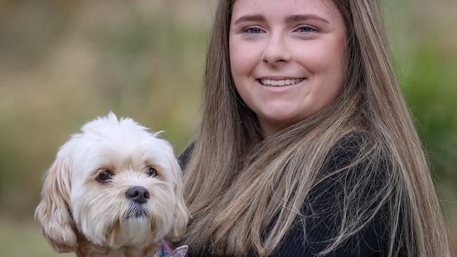 Taya, 16, with faithful pet Marley. She was frustrated by being told here pain was caused by anxiety. In December she was diagnosed with endometriosis. Picture: Ian Currie